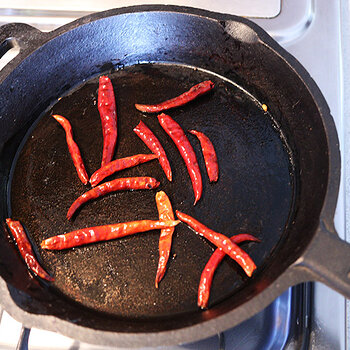 Frying dried chiles.