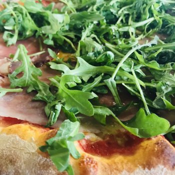 Pizza with rocket salad and speck ham.jpeg