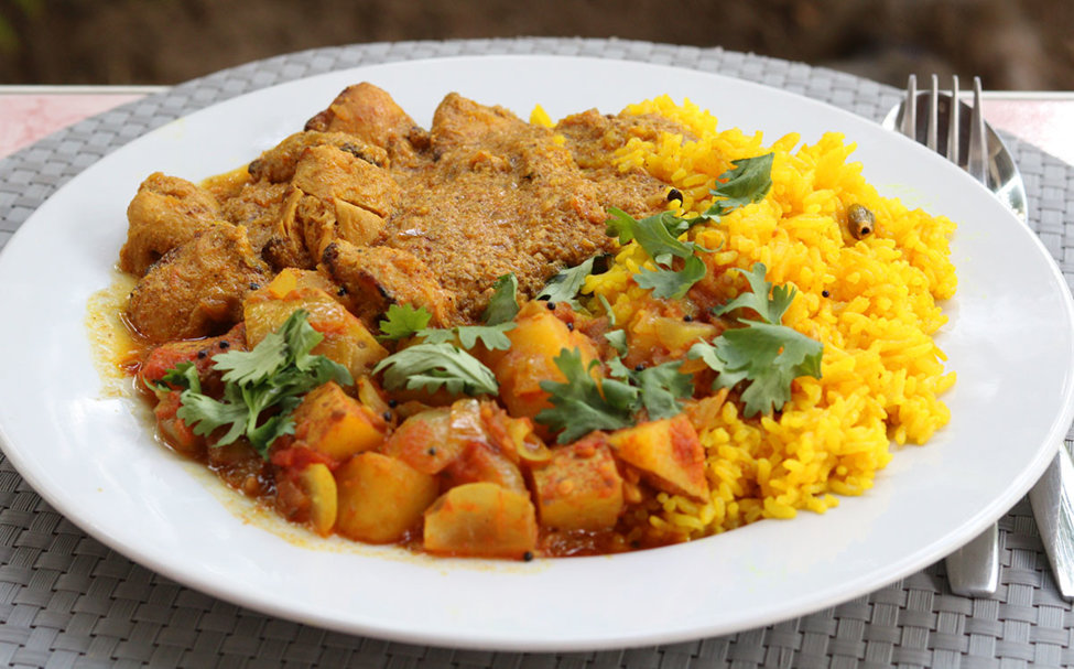 Chicken tikka masala with potato and onion bhaji and yellow aromatic rice.