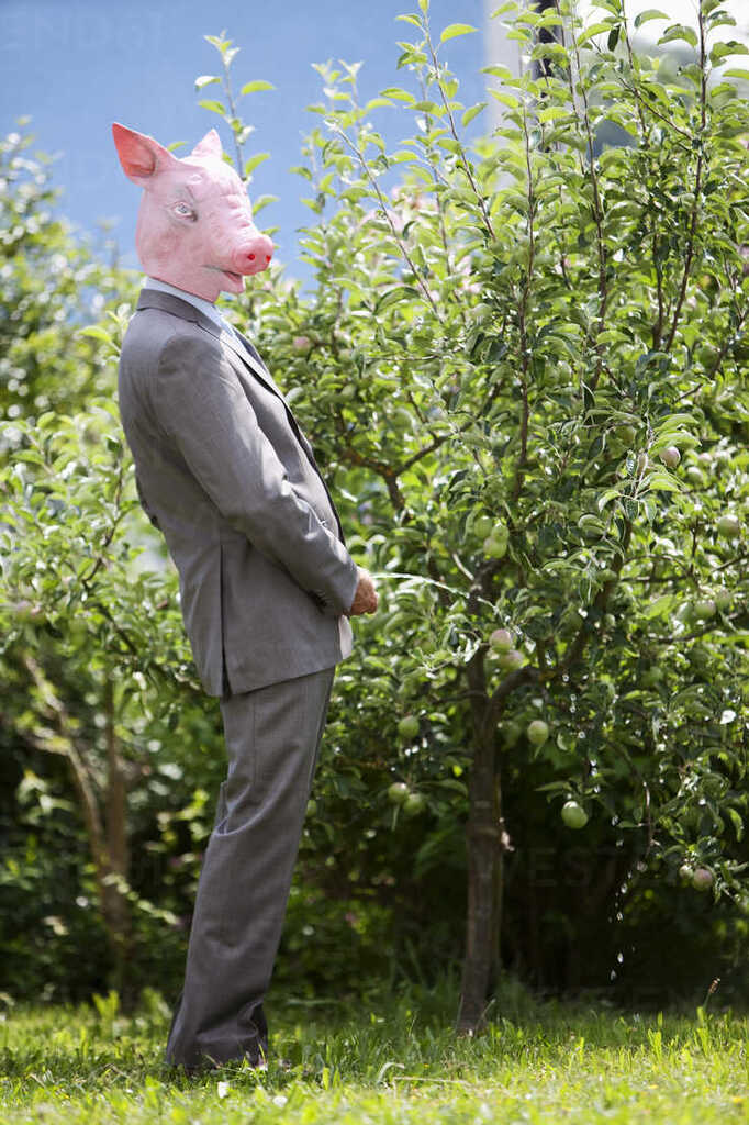 essman-with-pigs-head-urinating-on-tree-MAEF003487.jpg