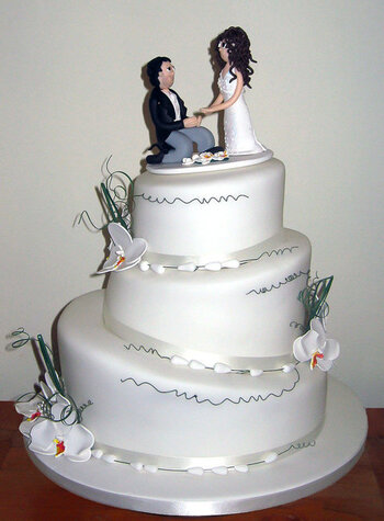 3-Tier-Topsy-Turvy-Ivory-Wedding-Cake-with-White-Orchids.jpg