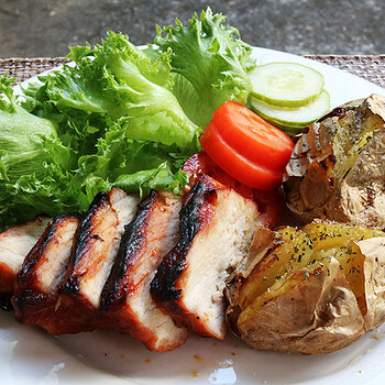 Char sui with grass and tomatoes and jacket potatoes.