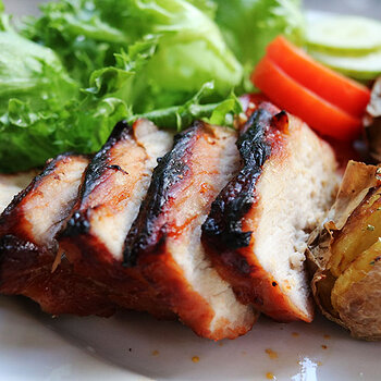 Char sui with grass and tomatoes and jacket potatoes.