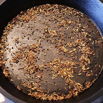 Dry frying cumin, fennugreek and black onion seeds.