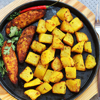 Spicy baked chicken with masala potatoes.