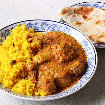 Tikka masala with aromatic rice and a roti.