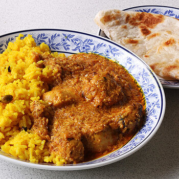 Tikka masala with aromatic rice and a roti.