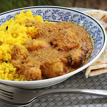 Tikka masala with aromatic rice and a roti.