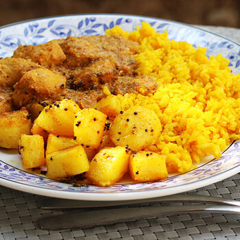 With Bombay potatoes and roti.