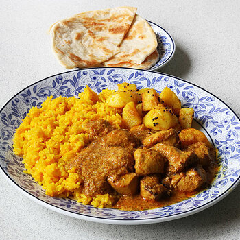 With Bombay potatoes and roti.