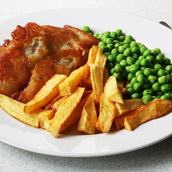 Battered pollock, chips and peas.