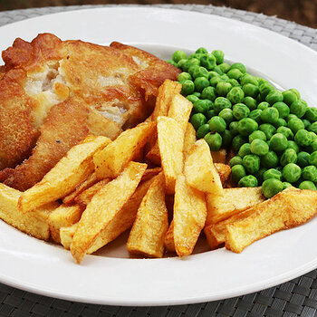 Battered pollock, chips and peas.