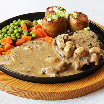 per steak with fondant potatoes, mushrooms, carrots and peas.