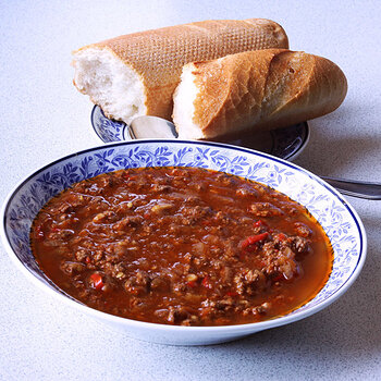 Chilli con carne with small baguette.