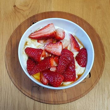 Strawberries, maple syrup, soaked oats in soya yoghurt