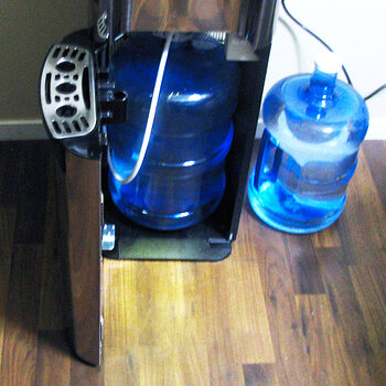 Distilled Water Jug in Dispenser with Bottom Load Pump Attached