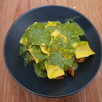 Shop bought vegan ravioli with homemade sorrel & almond pesto and a veggie burger underneath