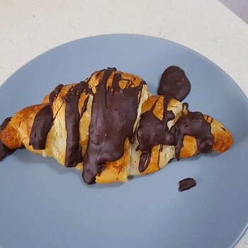 A slightly battered vegan chocolate croissant