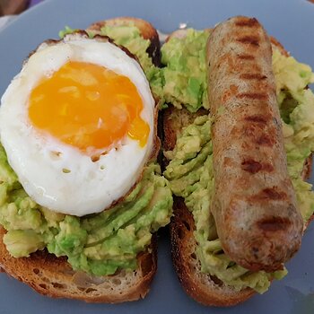 Vegan Chicken 'sausage' & fried egg on smashed Avo on sourdough toast