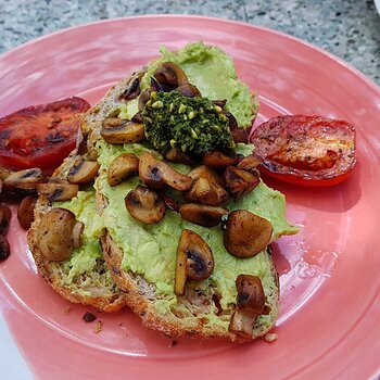 Smashed Avo, fried mushrooms, fried tomatoes with a vegan pesto on toasted sourdough