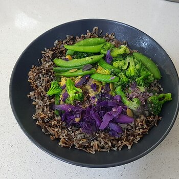 Vegan meal in a bowl with additional wild rice