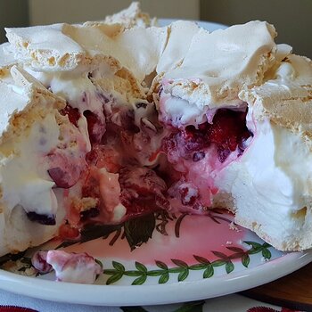 The pavlova with whipped cream and red berries (dairy free)