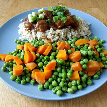 Vegan Orange Glazed Tofu served with brown basmati rice, peas and carrots