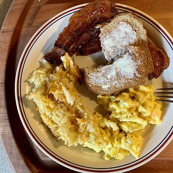 Scrambled Eggs With Butter Cheese, Hash Brown Casserole, Bacon, And Toast
