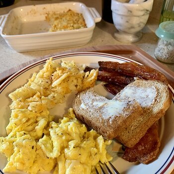 Scrambled Eggs With Butter Cheese, Hash Brown Casserole, Bacon, And Toast