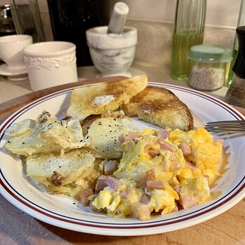 Scrambled Eggs W/ Ham And Cheese, Potatoes, And Toast