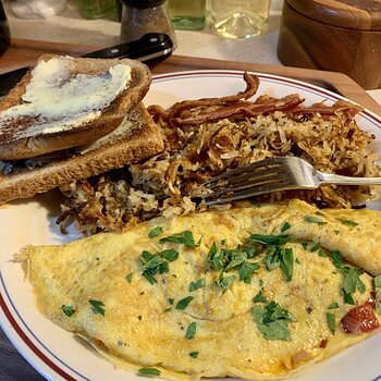 Omelette, Shredded Potatoes, Bacon, And Toast