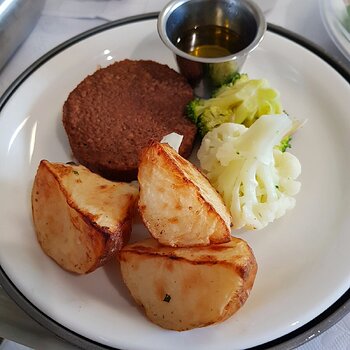 Vegan Pattie with baked potato, cauliflower & broccoli