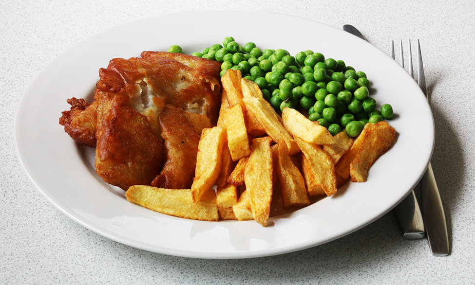 Battered pollock, chips and peas.