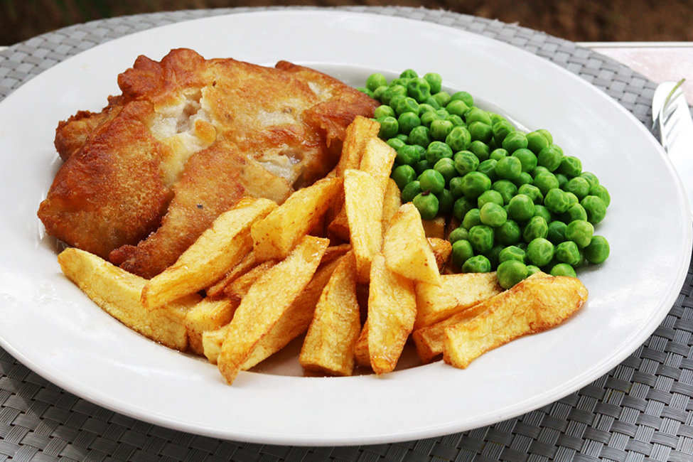 Battered pollock, chips and peas.