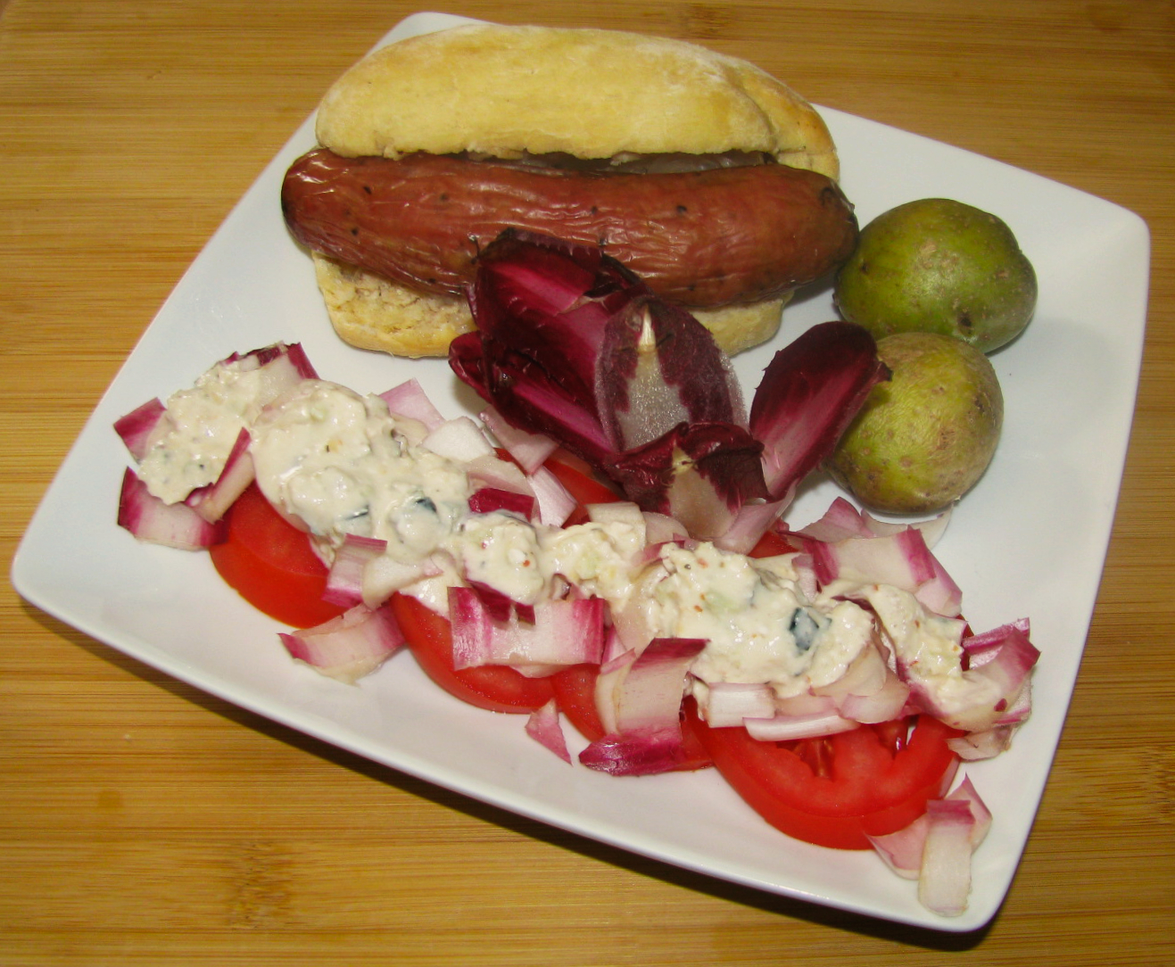 Bratwurst Sandwich with Potatoes and Endive Tomato Salad