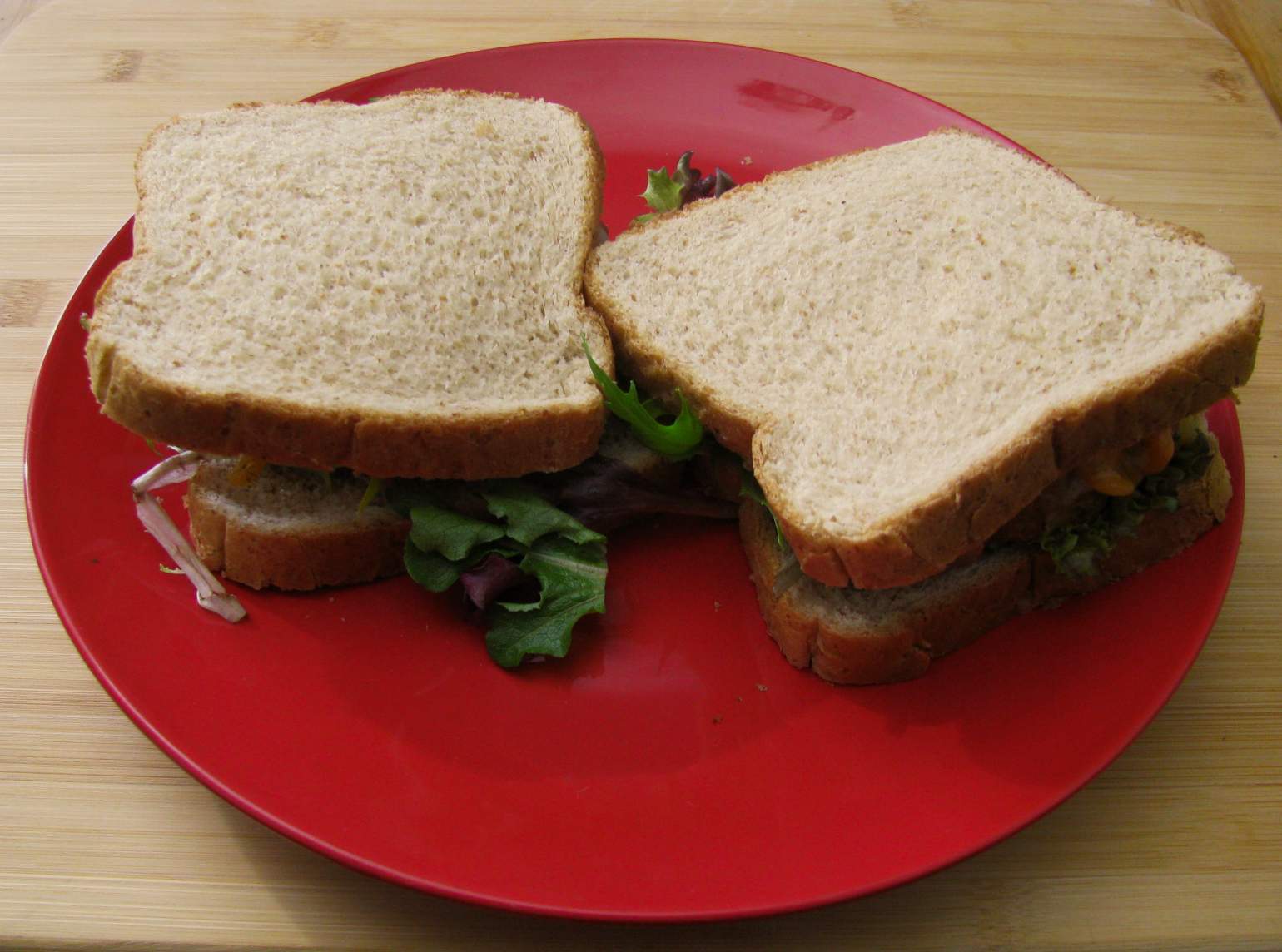 Breaded Chicken Sandwiches with Bacon and Cheese over Lettuce with Habnero Salsa