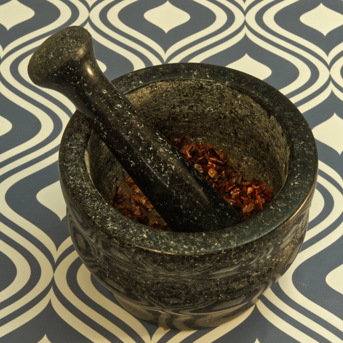 Crushed Dry Heated Chiles De Arbol using Mortar and Pestle
