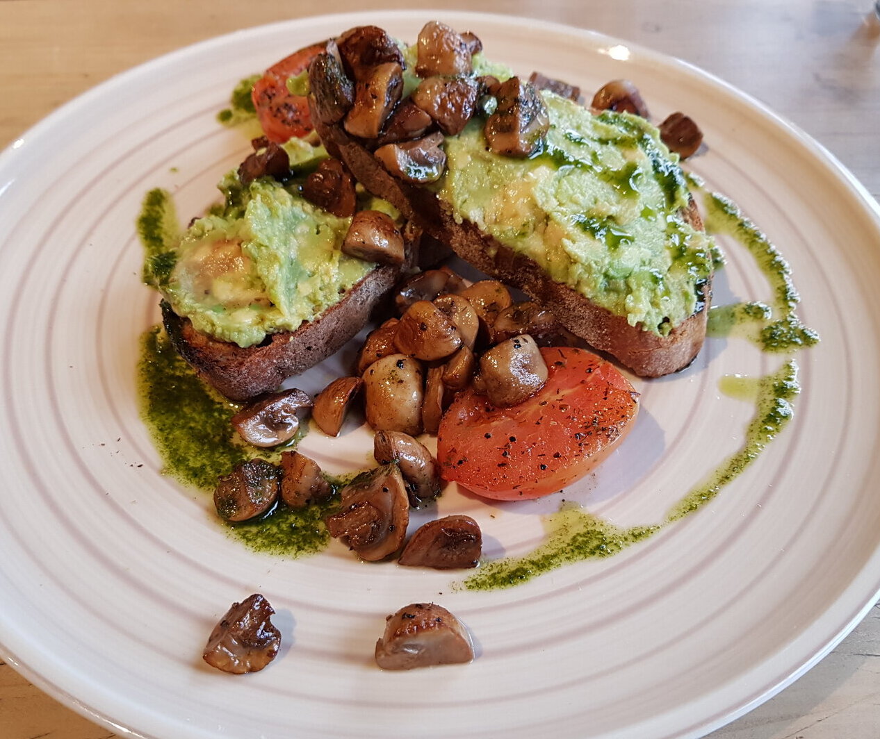 Mashed Avo on Sourdough with fried mushrooms, fried tomatoes & vegan pesto