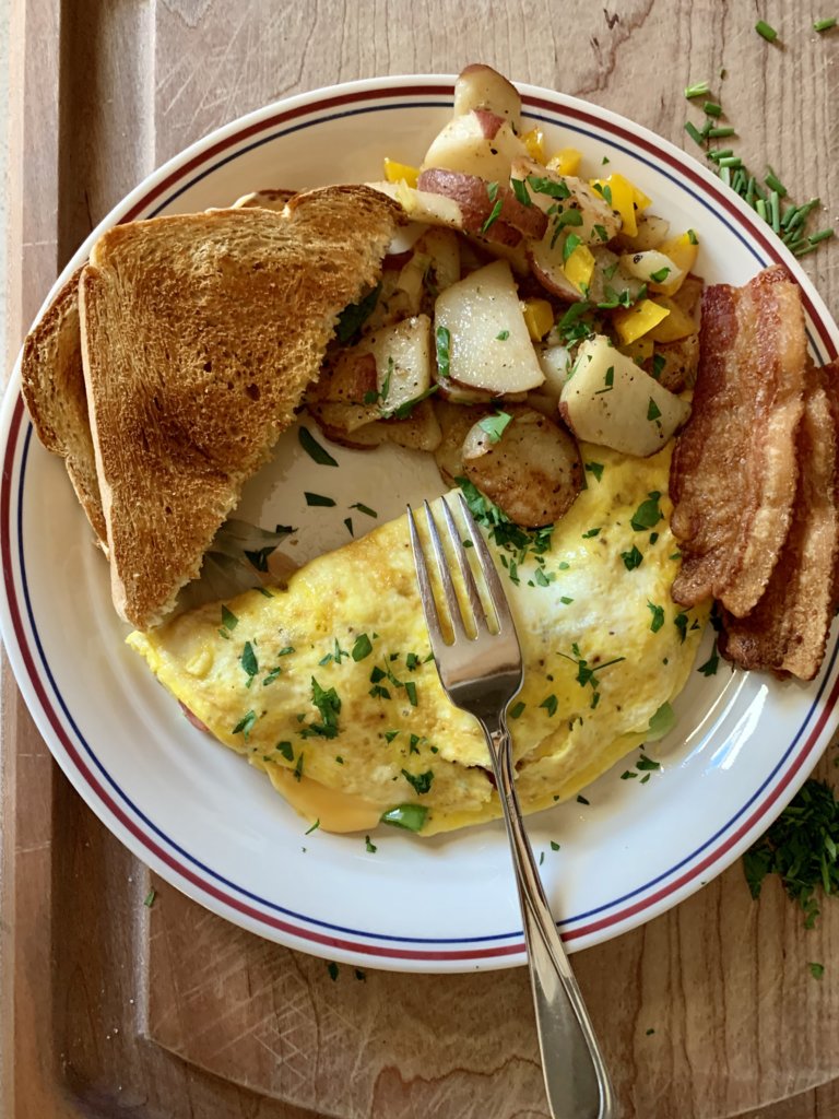 Omelette, Potatoes, Bacon, And Toast