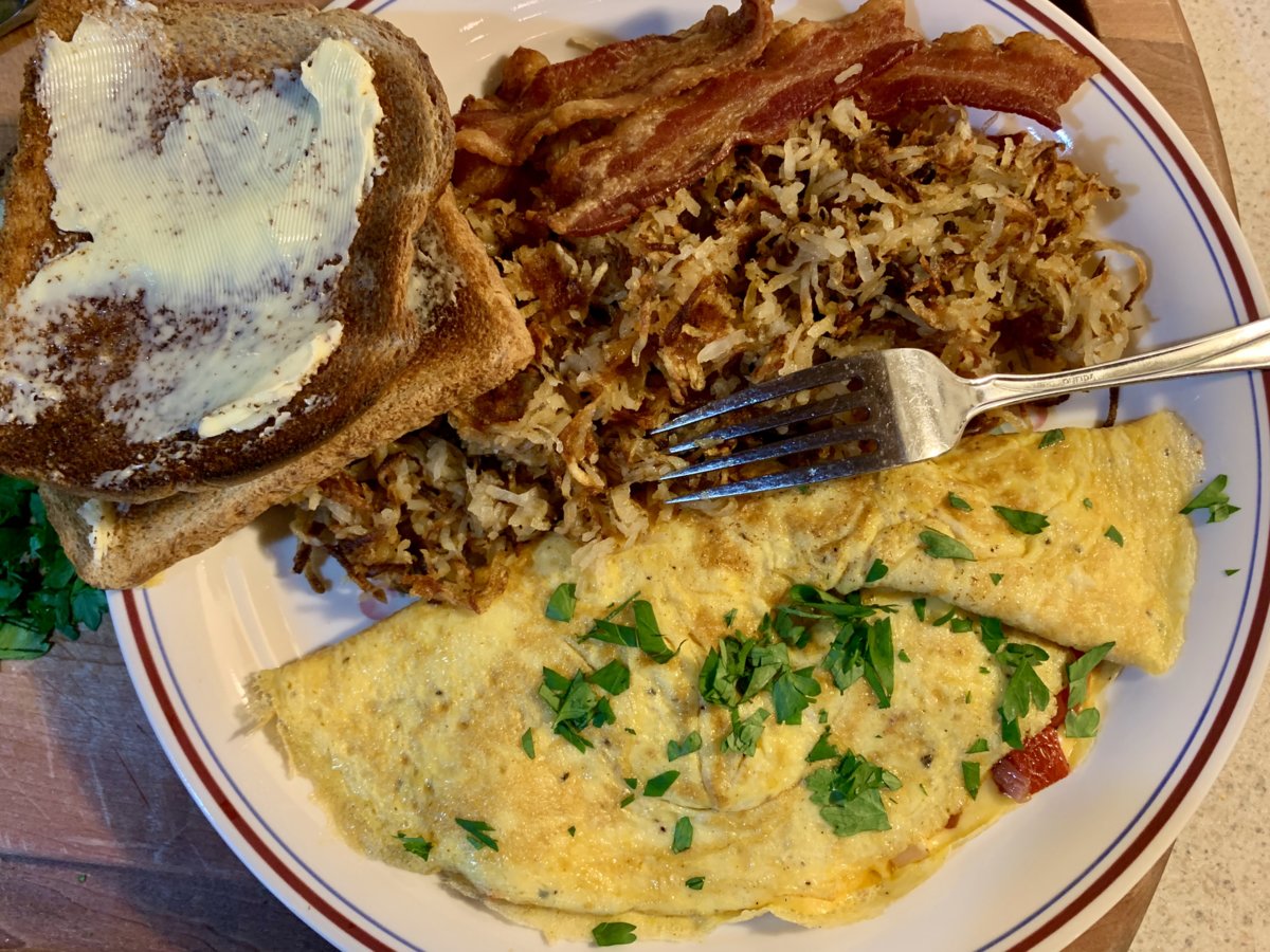 Omelette, Shredded Potatoes, Bacon, And Toast