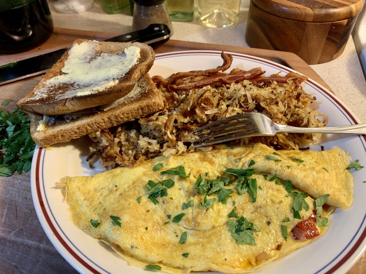 Omelette, Shredded Potatoes, Bacon, And Toast