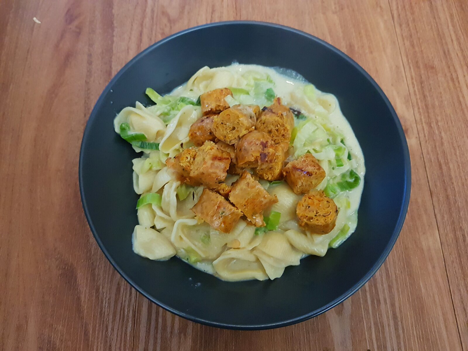 Pasta with a creamy leek sauce and sausages