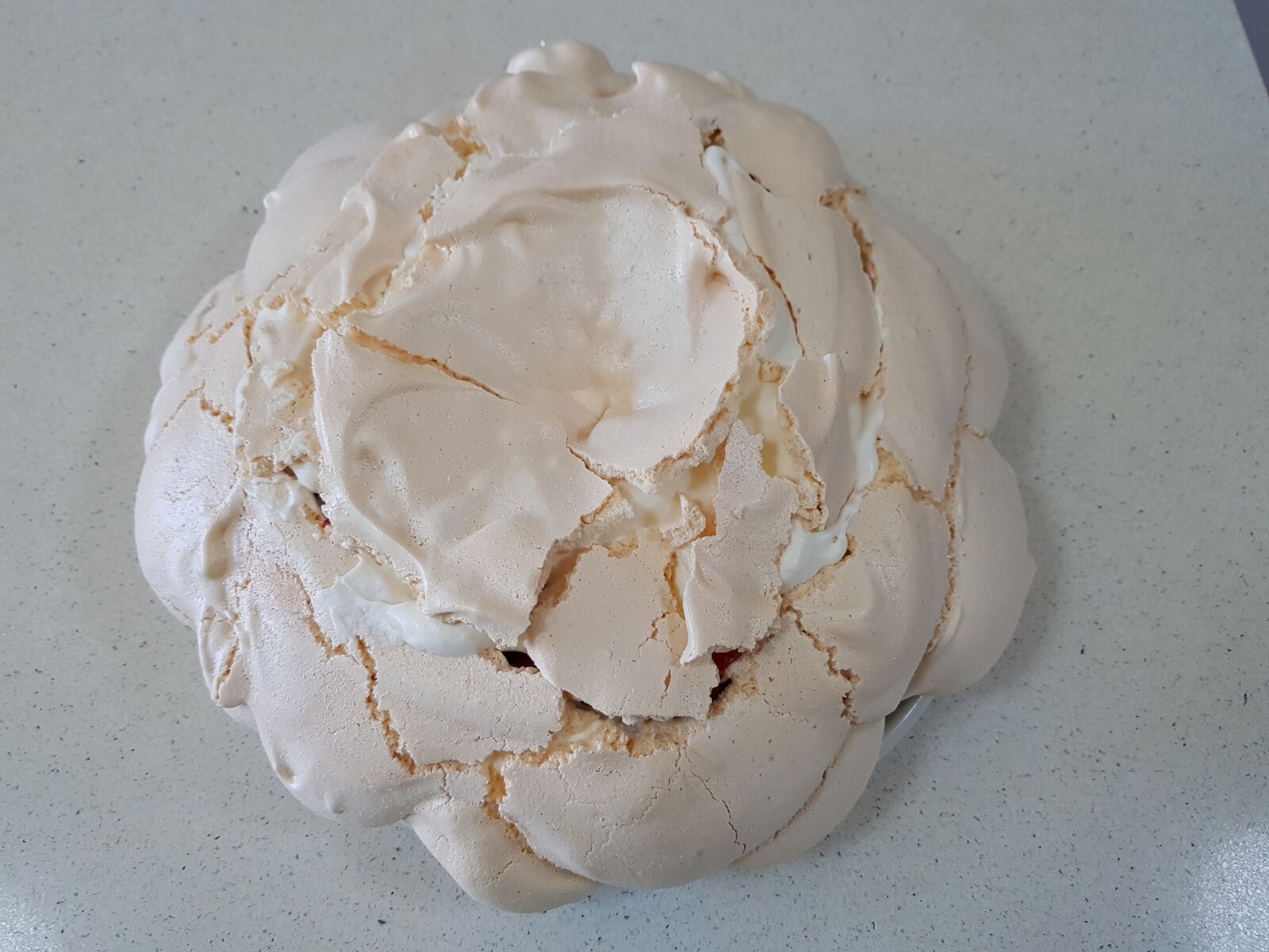 Pavlova filled with the top reassembled