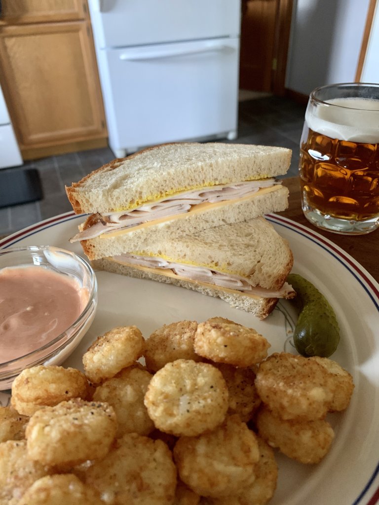 Peppered Deli Chicken Sandwich, Crispy Crown Potatoes, Pickle, And Beer