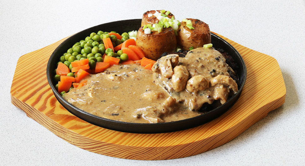 per steak with fondant potatoes, mushrooms, carrots and peas.