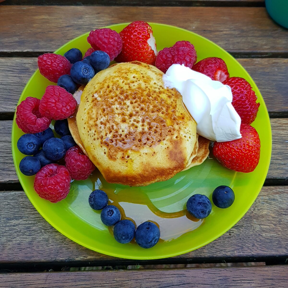 Pikelets, raspberries, strawberries, blueberries, maple syrup & a plant based whipping cream