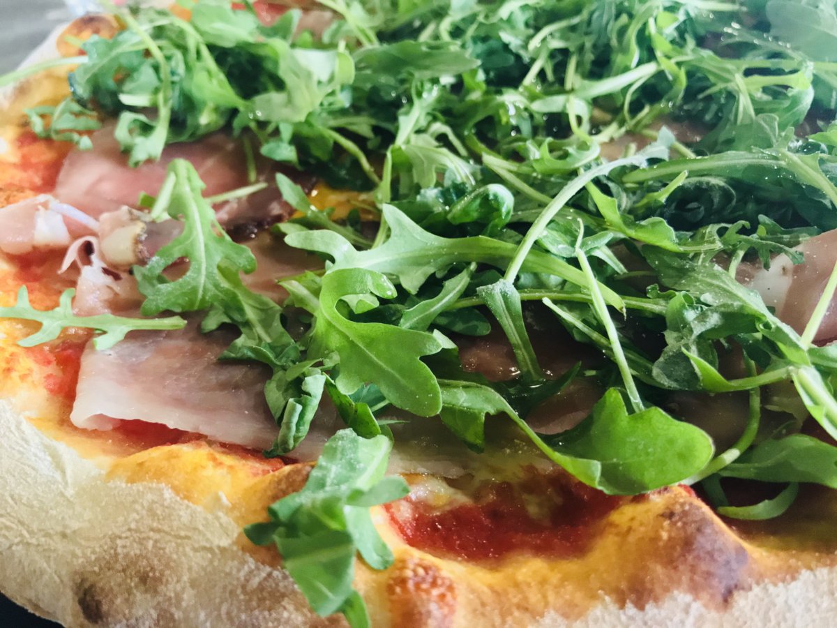 Pizza with rocket salad and speck ham.jpeg