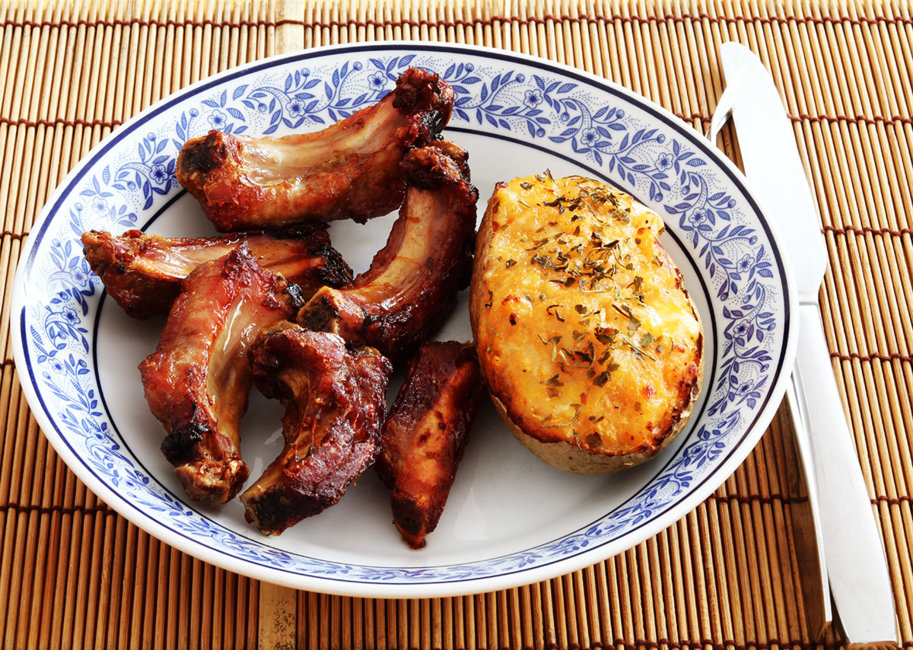 Pork ribs with honey and stuffed jacket potato.