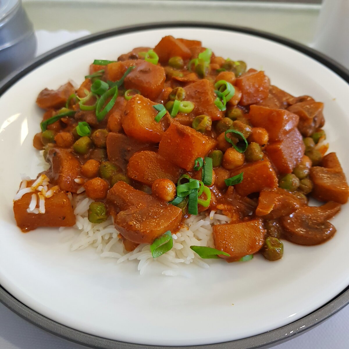 Potato curry with peas and mushroom served with basmati rice