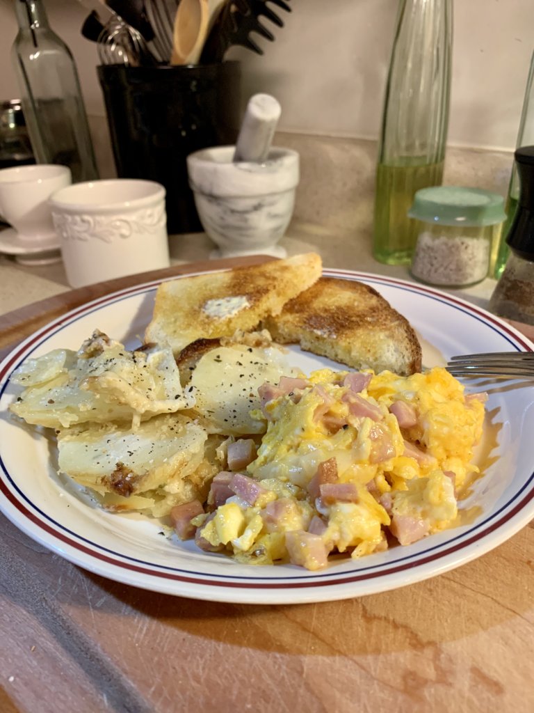 Scrambled Eggs W/ Ham And Cheese, Potatoes, And Toast